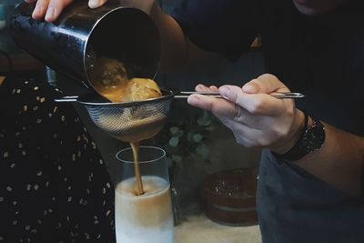 Midsection of man preparing food in kitchen