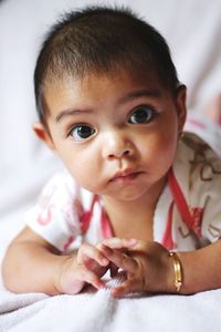 Close-up portrait of cute baby at home