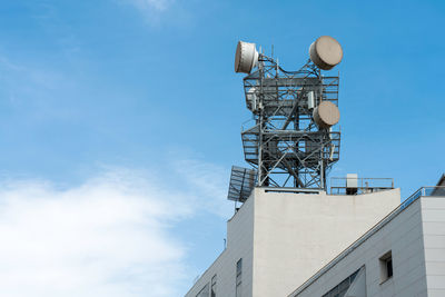 Low angle view of communications tower against sky