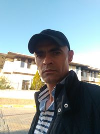 Portrait of man standing against sky