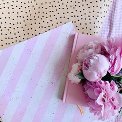 Close-up of pink rose on table