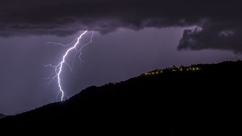 Low angle view of lightning against sky at night