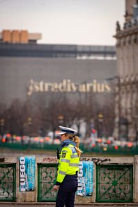 Man wearing hat standing against graffiti