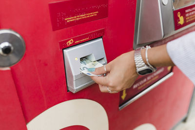 Woman removing money from atm machine