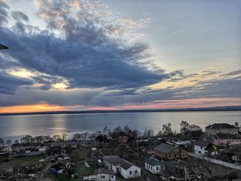 High angle view of townscape by sea against sky