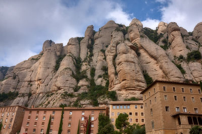 Low angle view of buildings against mountain