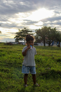 Full length of boy standing on field