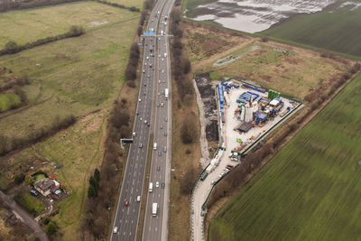 High angle view of cars on a motorway in the uk and a fracking site