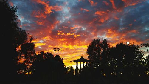 Silhouette trees against sky during sunset