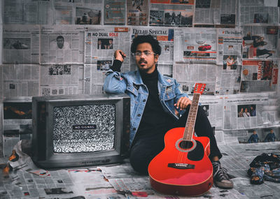 Portrait of a young man playing guitar