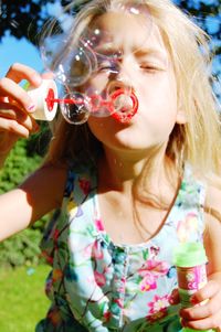 Close-up of girl holding bubbles