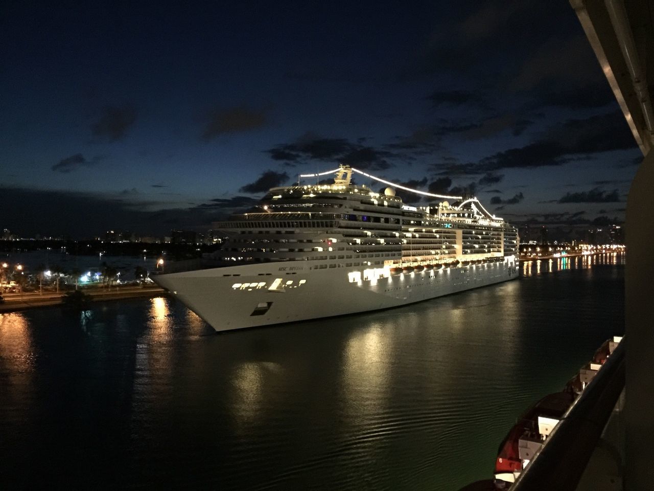 illuminated, architecture, built structure, water, night, building exterior, sky, city, river, cityscape, sea, reflection, transportation, waterfront, connection, bridge - man made structure, high angle view, dusk, travel destinations, nautical vessel