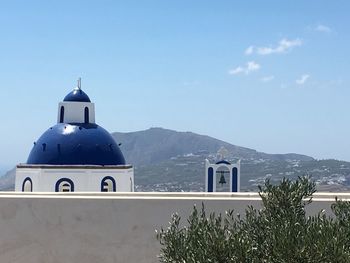 Church by building against sky