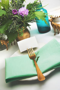 Close-up of napkin by decoration in plate on table