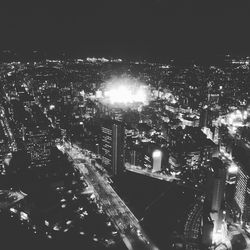 Illuminated cityscape against sky at night