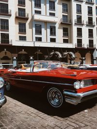 Cars on street against buildings in city