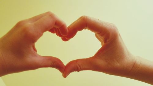 Close-up of hands holding heart shape