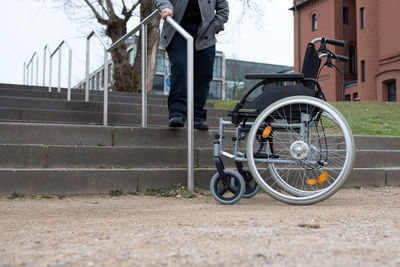 A physically disabled person in a wheelchair trying to go down the stairs.