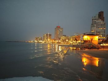 Illuminated city at waterfront