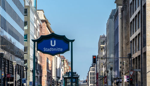 Low angle view of road sign against buildings