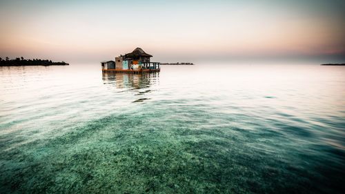 Scenic view of sea against sky at sunset