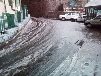 Snow covered road in city