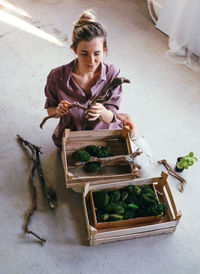 High angle view of woman sitting in basket