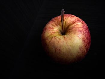 High angle view of apple on table against black background