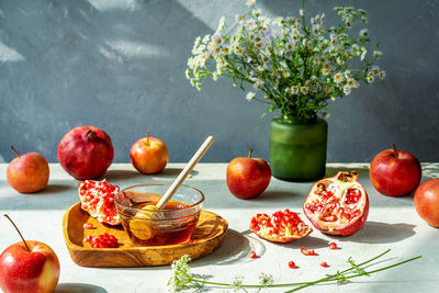 Pomegranates, apples and honey. rosh hashanah celebration and autumn harvesting concept