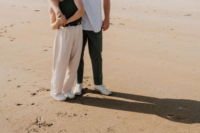 Rear view of woman walking at beach