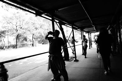 Full length of woman standing by railing