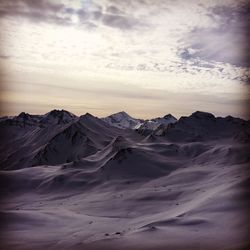 Scenic view of snow covered mountains against sky