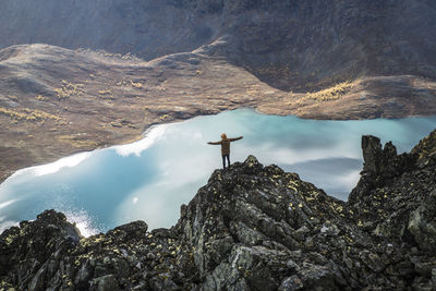 Scenic view of mountains by lake against sky