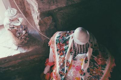 Traditional clothing and seashells in glass container