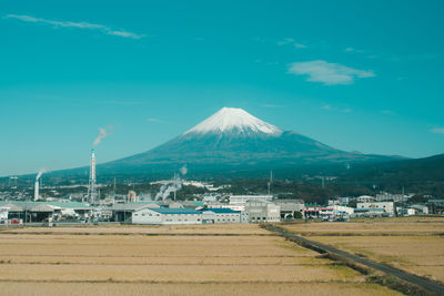 Scenic view of residential district against blue sky