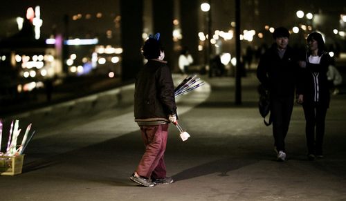 Rear view of woman dancing at night