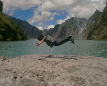 Man on shore against sky