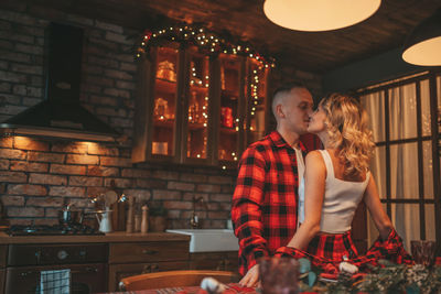 Candid authentic happy married couple spends time alone at lodge xmas decorated