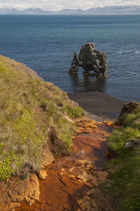 High angle view of rocks at sea shore against sky