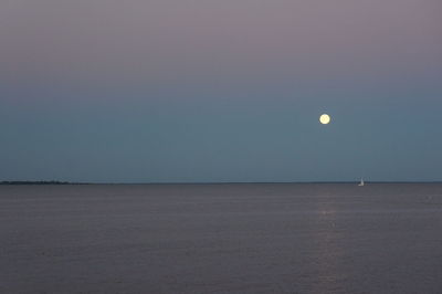 Scenic view of sea against clear sky at night