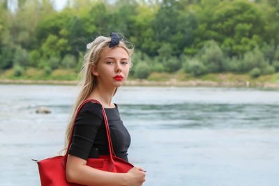 Portrait of girl standing by lake