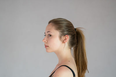 Portrait of a young woman against white background