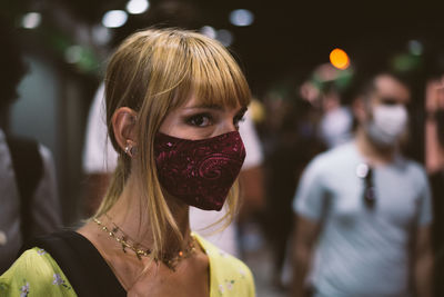 Close-up of woman wearing mask standing outdoors