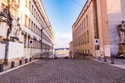 Footpath amidst buildings in city