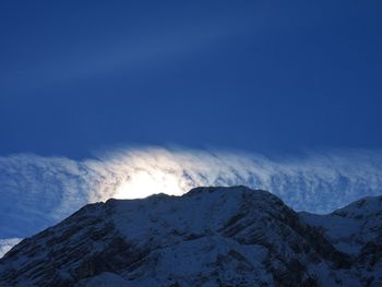 Scenic view of snowcapped mountains against clear blue sky