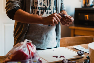 Midsection of man preparing food on table at home