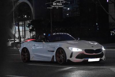 View of car on illuminated street at night