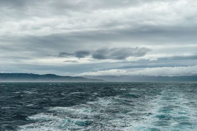 Scenic view of sea against storm clouds