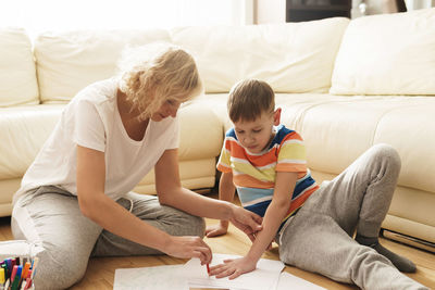 High angle view of mother and daughter on bed at home