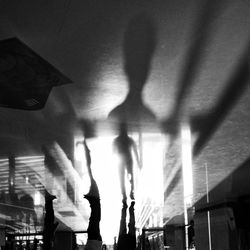 Low angle view of people walking in illuminated building